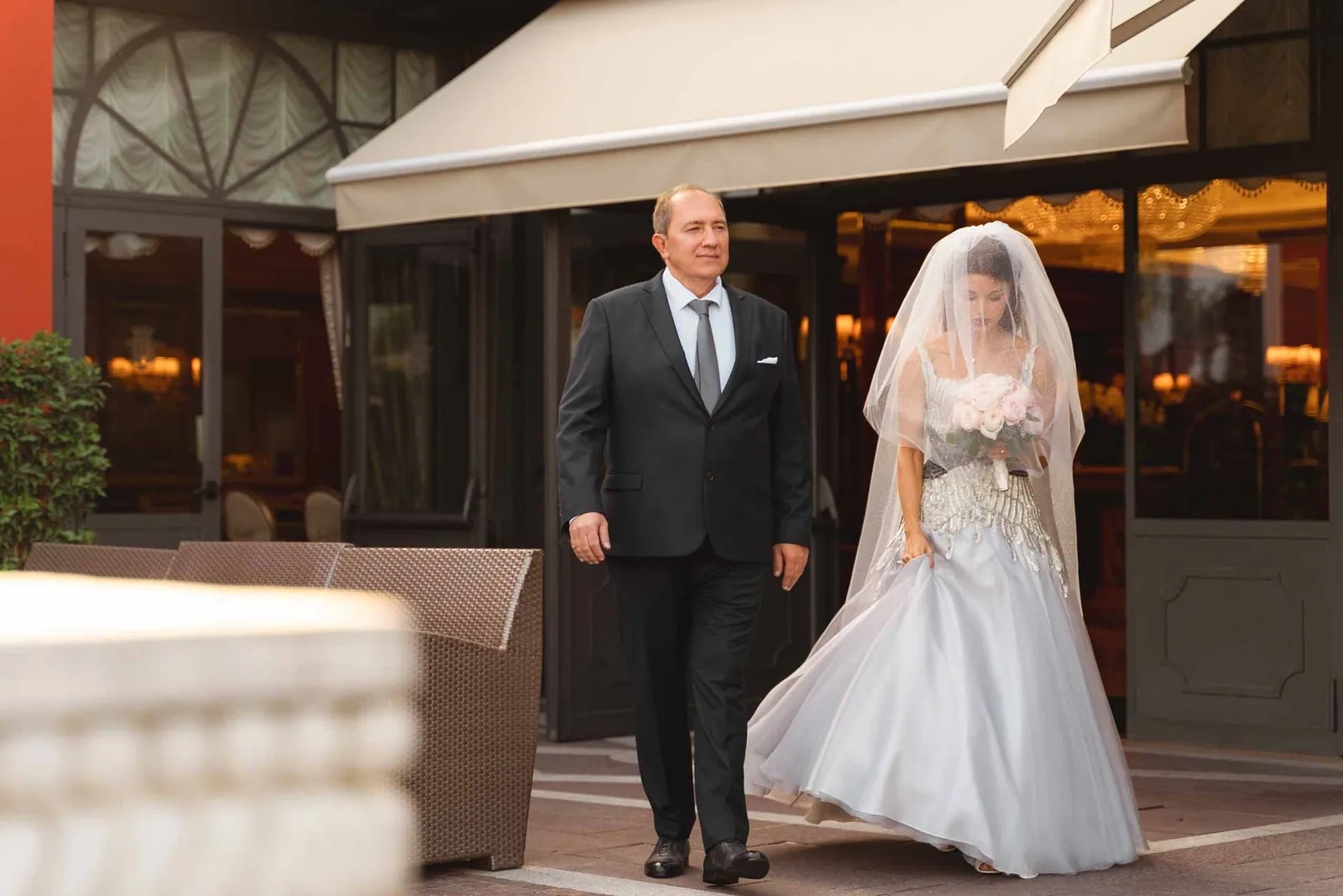 La sposa esce dallo Splendid Hotel sottobraccio a un uomo in abito scuro