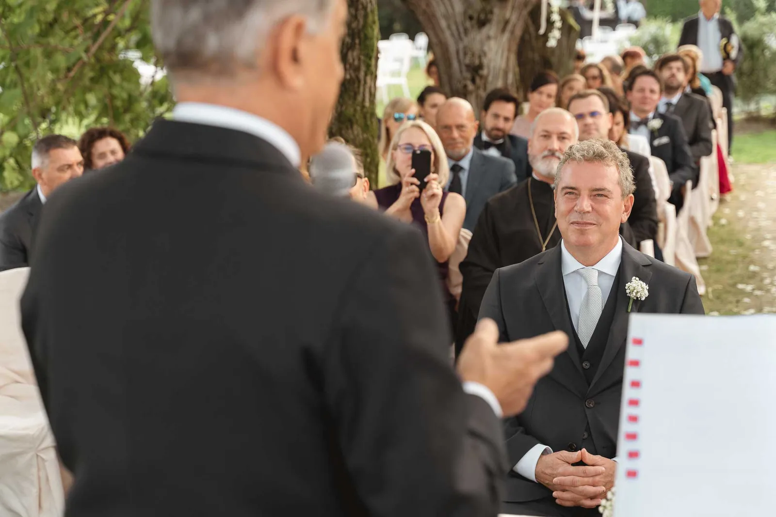 Un amico parla agli sposi davanti agli invitati