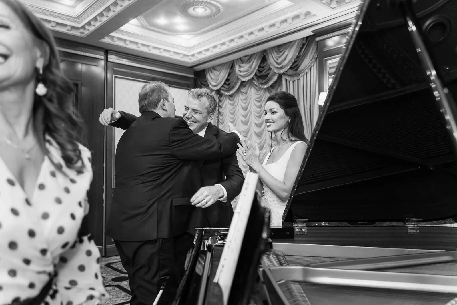 In bianco e nero, un abbraccio accanto al pianoforte
