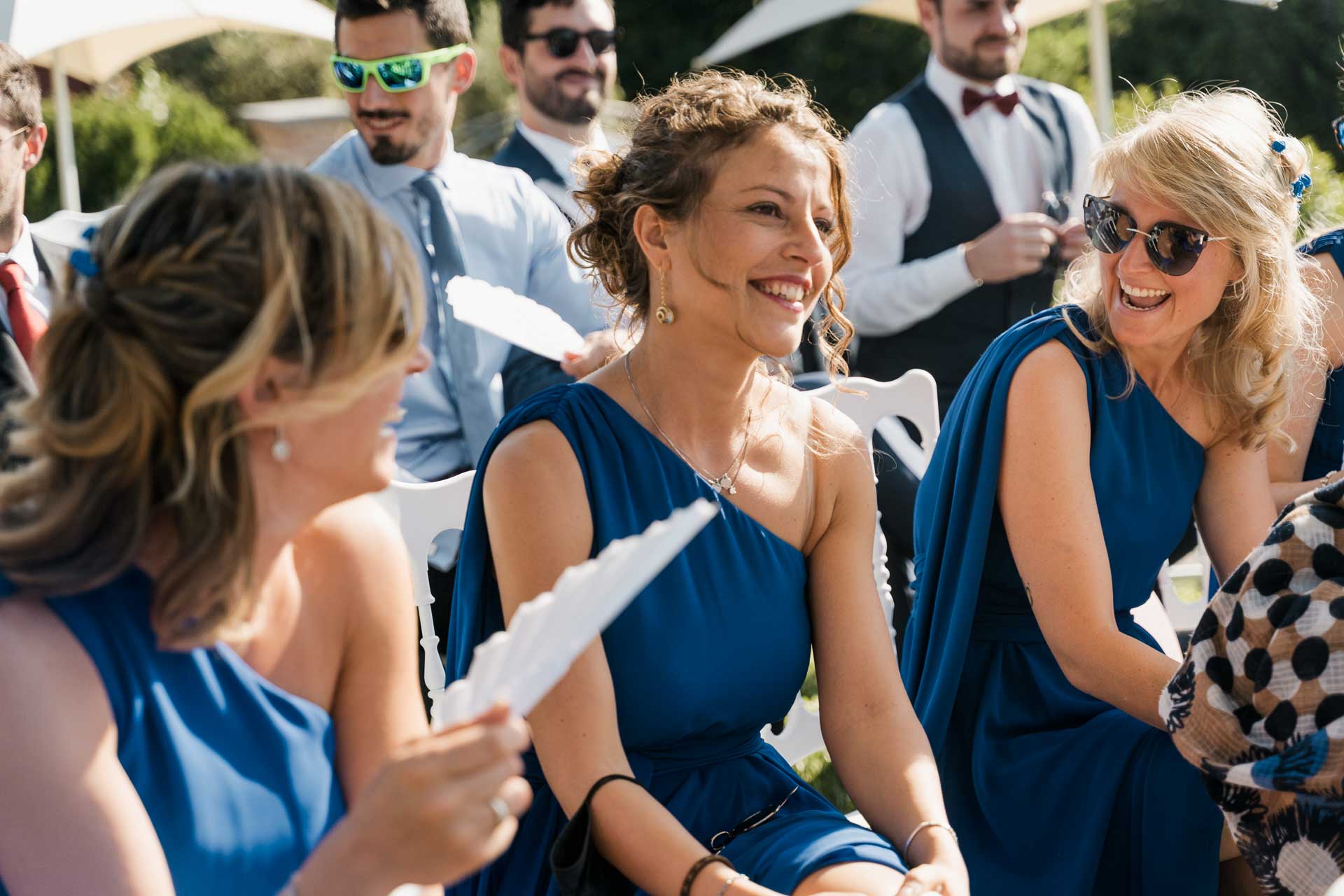Le amiche in blu ridono con i ventagli in mano