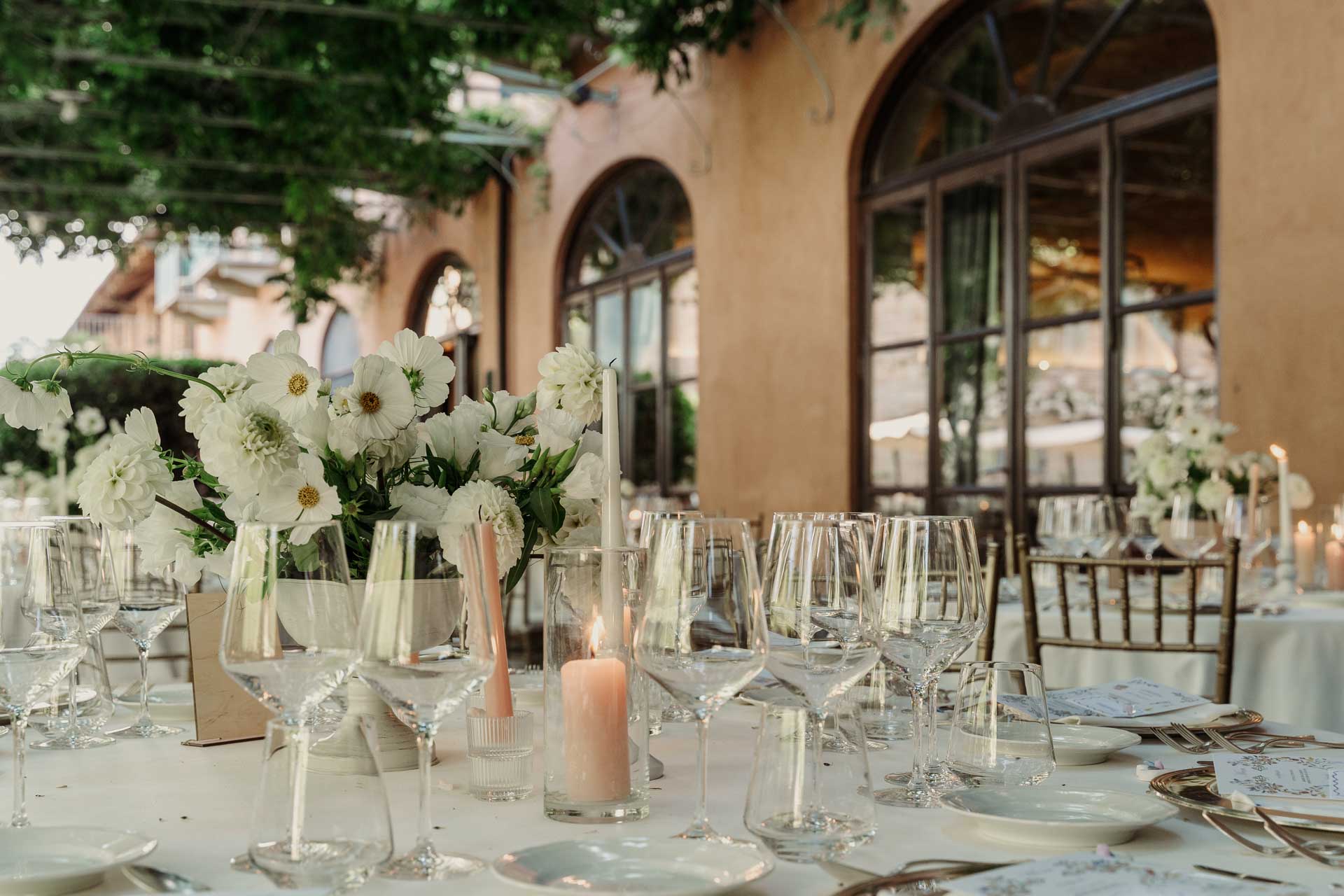 I calici e i fiori bianchi sulla tavola, davanti al relais